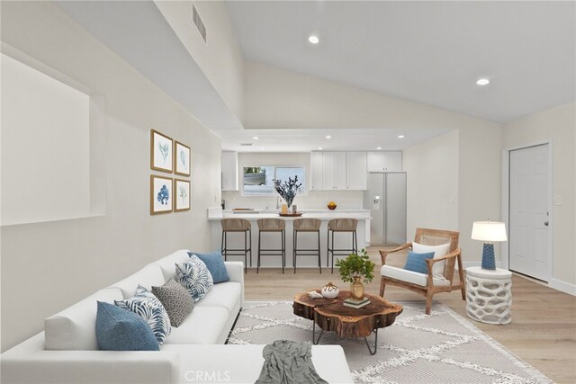 12847 Winthrop Ave, Granada Hills, CA 91344 - living area with light wood-style flooring, vaulted ceiling, and recessed lighting