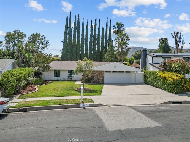 12847 Winthrop Ave, Granada Hills, CA 91344 - view of front of house featuring a front yard, driveway, and an attached garage