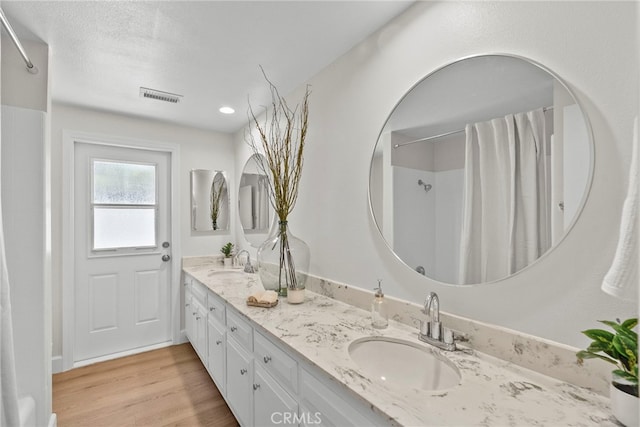 12847 Winthrop Ave, Granada Hills, CA 91344 - bathroom featuring double vanity, a shower with shower curtain, and wood finished floors