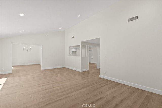 12847 Winthrop Ave, Granada Hills, CA 91344 - unfurnished living room featuring vaulted ceiling, light wood-style floors, recessed lighting, and a chandelier
