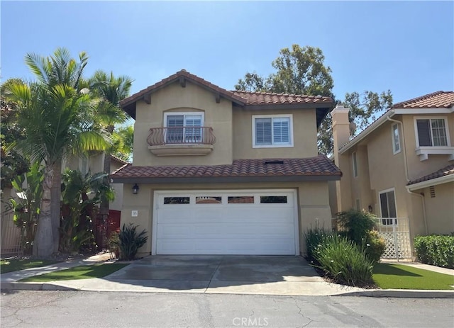 35 Via Caseta, Rancho Santa Margarita, CA 92688 - mediterranean / spanish home featuring a garage, a tile roof, driveway, and stucco siding