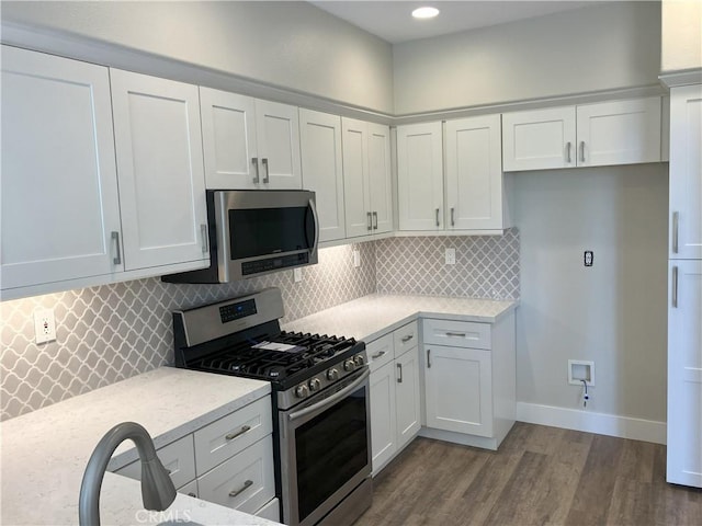 35 Via Caseta, Rancho Santa Margarita, CA 92688 - kitchen with stainless steel appliances, dark wood-style floors, white cabinets, decorative backsplash, and recessed lighting