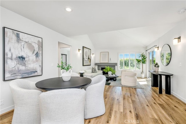 503 Morning Canyon Rd Unit 9, Corona Del Mar, CA 92625 - dining room featuring vaulted ceiling, light wood-style flooring, a fireplace, and recessed lighting