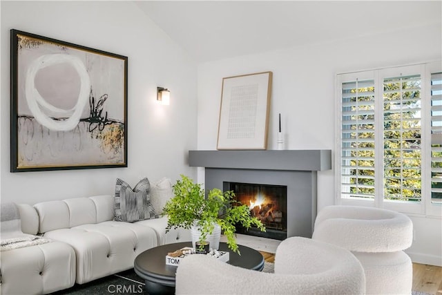503 Morning Canyon Rd Unit 9, Corona Del Mar, CA 92625 - living room featuring a fireplace with flush hearth, vaulted ceiling, and wood finished floors