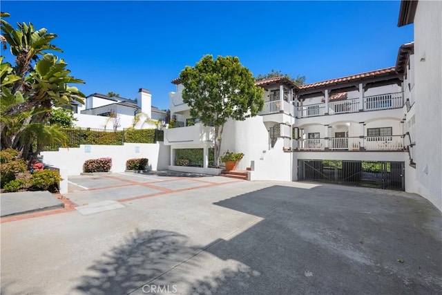 503 Morning Canyon Rd Unit 9, Corona Del Mar, CA 92625 - view of front of home featuring stucco siding, a tile roof, and a gate