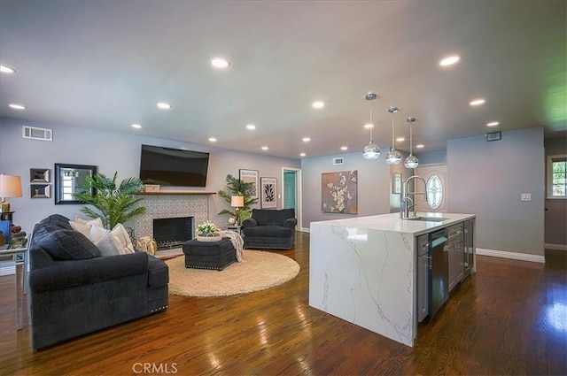 1375 N Euclid Ave, Upland, CA 91786 - kitchen featuring open floor plan, dark wood-style flooring, light stone countertops, dishwasher, and a kitchen island with sink