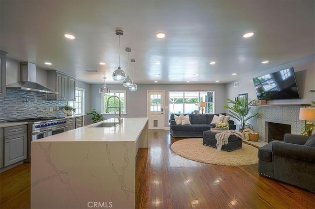 1375 N Euclid Ave, Upland, CA 91786 - kitchen with open floor plan, gray cabinets, wall chimney exhaust hood, a fireplace, and light stone countertops
