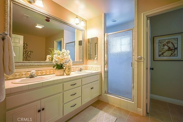 1375 N Euclid Ave, Upland, CA 91786 - bathroom featuring double vanity, a shower stall, tile patterned flooring, and decorative backsplash
