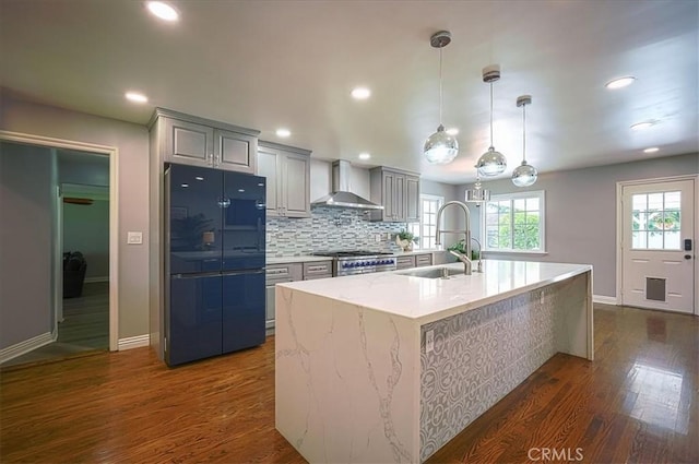 1375 N Euclid Ave, Upland, CA 91786 - kitchen featuring freestanding refrigerator, wall chimney exhaust hood, dark wood-style floors, an island with sink, and recessed lighting
