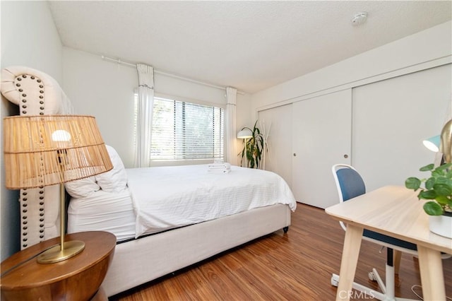 9 Morena Unit 28, Irvine, CA 92612 - bedroom featuring a closet and wood finished floors