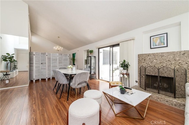 9 Morena Unit 28, Irvine, CA 92612 - living room with a fireplace with raised hearth, a chandelier, wood finished floors, and high vaulted ceiling