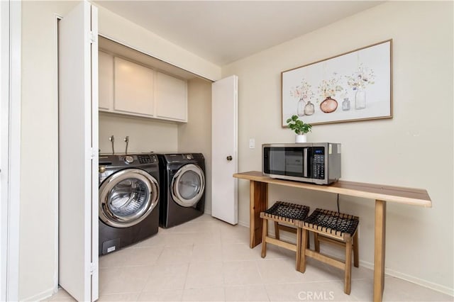 9 Morena Unit 28, Irvine, CA 92612 - laundry area featuring washer and dryer, cabinet space, and light tile patterned floors