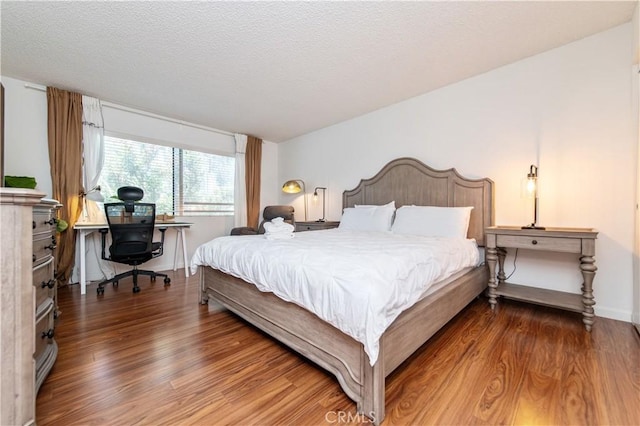 9 Morena Unit 28, Irvine, CA 92612 - bedroom featuring wood finished floors, a desk, and a textured ceiling