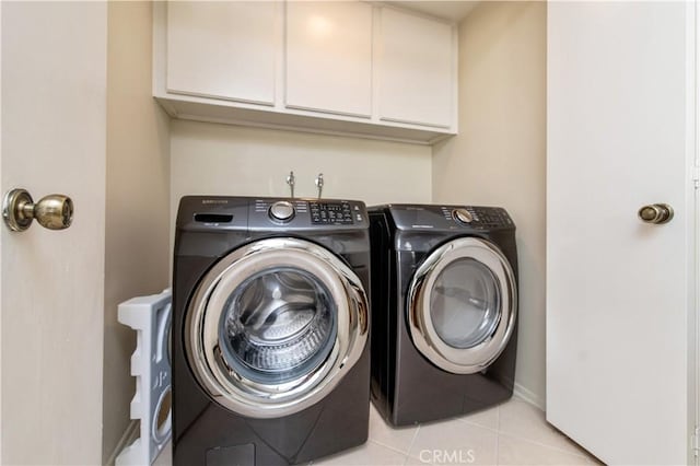 9 Morena Unit 28, Irvine, CA 92612 - laundry area with washer and dryer, light tile patterned flooring, and cabinet space
