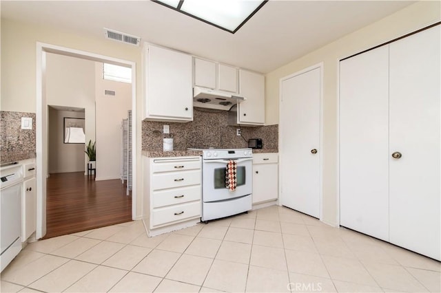 9 Morena Unit 28, Irvine, CA 92612 - kitchen with electric range, ventilation hood, tasteful backsplash, white cabinetry, and light tile patterned floors