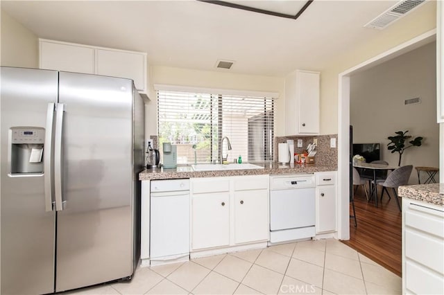 9 Morena Unit 28, Irvine, CA 92612 - kitchen with stainless steel refrigerator with ice dispenser, dishwasher, white cabinets, light countertops, and tasteful backsplash