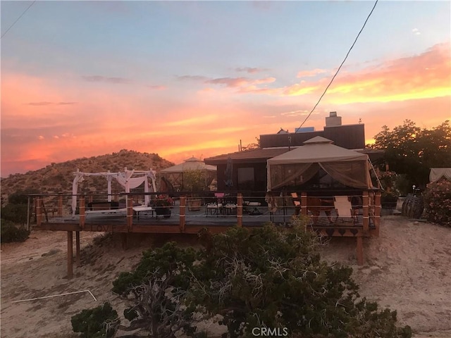 56564 Nelson Ave, Yucca Valley, CA 92284 - back of house featuring a gazebo, a chimney, and a wooden deck