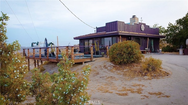 56564 Nelson Ave, Yucca Valley, CA 92284 - rear view of house with a chimney and a wooden deck