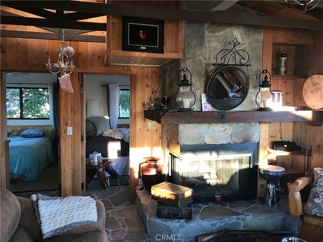 56564 Nelson Ave, Yucca Valley, CA 92284 - living area with wood walls, a chandelier, healthy amount of natural light, and a fireplace