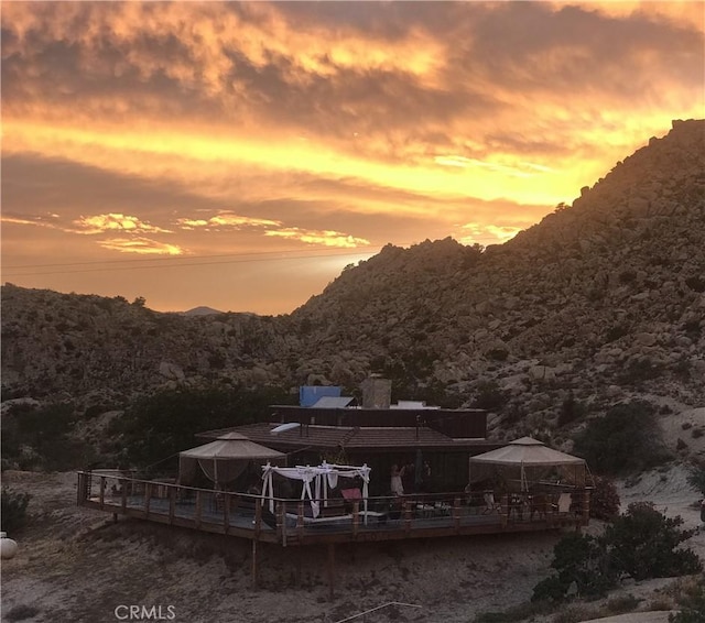 56564 Nelson Ave, Yucca Valley, CA 92284 - back of property at dusk with a gazebo, a deck with mountain view, and a wooded view