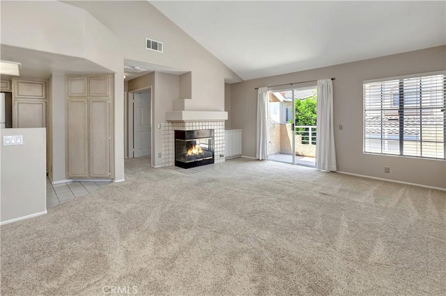 27982 Via Del Agua, Laguna Niguel, CA 92677 - unfurnished living room featuring light carpet, a tile fireplace, and high vaulted ceiling