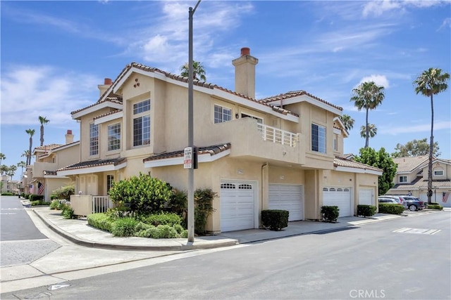 27982 Via Del Agua, Laguna Niguel, CA 92677 - view of property exterior featuring an attached garage, a chimney, stucco siding, and a tile roof