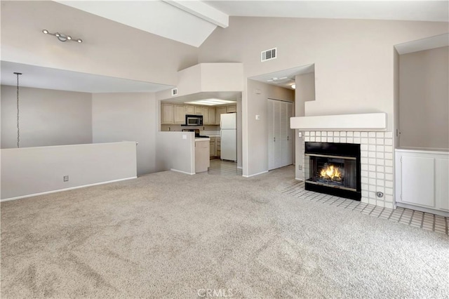 27982 Via Del Agua, Laguna Niguel, CA 92677 - unfurnished living room with light colored carpet, high vaulted ceiling, a tiled fireplace, and beamed ceiling