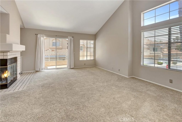 27982 Via Del Agua, Laguna Niguel, CA 92677 - unfurnished living room with plenty of natural light, carpet flooring, a fireplace, and vaulted ceiling