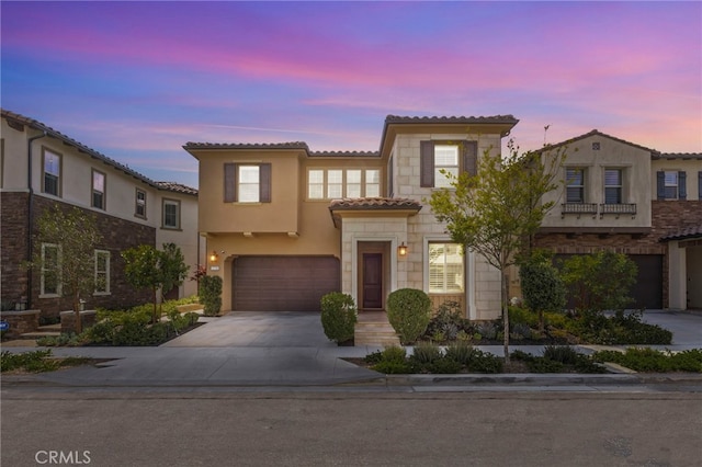 1776 Canyon Oaks Ln, Lake Forest, CA 92610 - mediterranean / spanish house with a garage, a tile roof, driveway, stucco siding, and stone siding