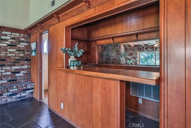 17654 Prairie St, Northridge, CA 91325 - bar area featuring dark tile patterned floors and wooden walls
