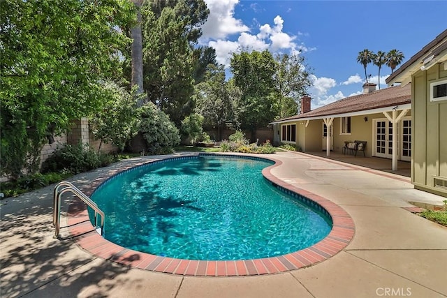 17654 Prairie St, Northridge, CA 91325 - view of swimming pool featuring a patio area, a fenced backyard, and french doors