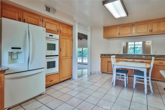 17654 Prairie St, Northridge, CA 91325 - kitchen featuring white appliances and light tile patterned floors