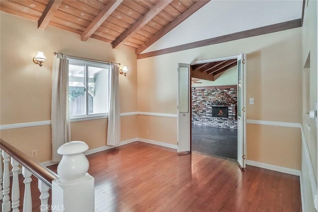 17654 Prairie St, Northridge, CA 91325 - empty room with wood ceiling, wood finished floors, and a brick fireplace