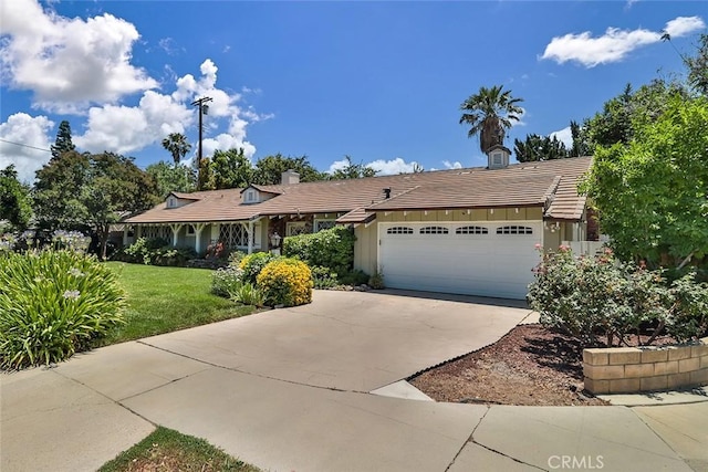17654 Prairie St, Northridge, CA 91325 - single story home with a garage, driveway, a front lawn, a chimney, and a tile roof
