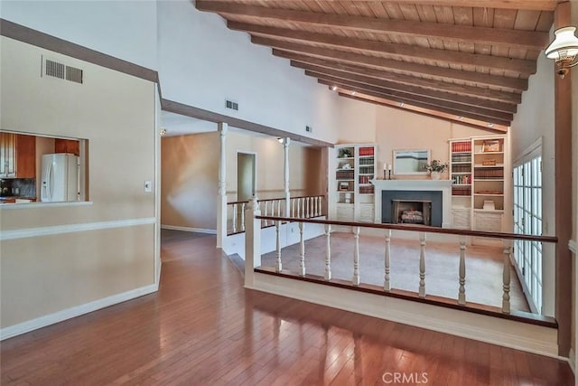17654 Prairie St, Northridge, CA 91325 - unfurnished living room featuring a wood ceiling with exposed beams, high vaulted ceiling, hardwood / wood-style flooring, and a fireplace