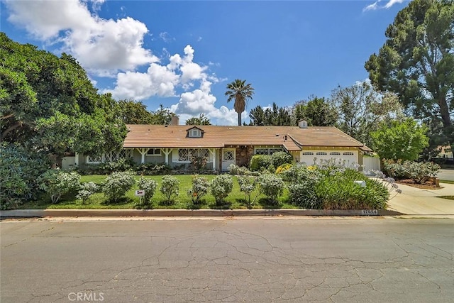 17654 Prairie St, Northridge, CA 91325 - ranch-style house featuring an attached garage, a chimney, and concrete driveway