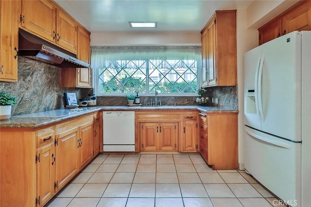 17654 Prairie St, Northridge, CA 91325 - kitchen with white appliances, under cabinet range hood, decorative backsplash, light tile patterned floors, and brown cabinets