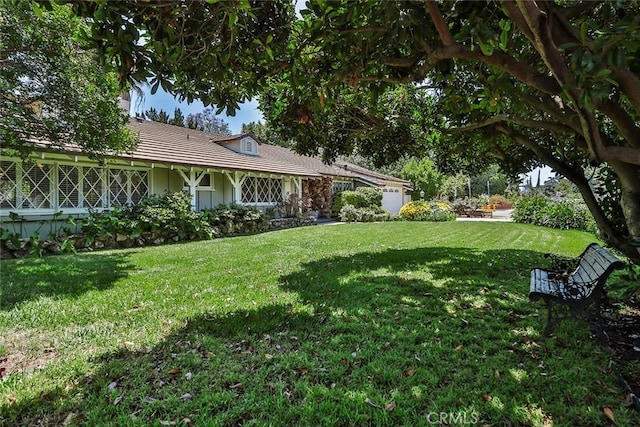 17654 Prairie St, Northridge, CA 91325 - view of grassy yard with an attached garage