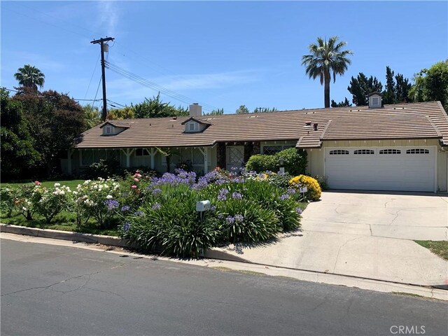 17654 Prairie St, Northridge, CA 91325 - ranch-style home with a chimney, an attached garage, a tile roof, and concrete driveway
