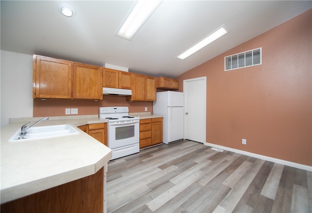 3556 Cypress St, Clearlake, CA 95422 - kitchen with white appliances, under cabinet range hood, lofted ceiling, light countertops, and light wood-type flooring