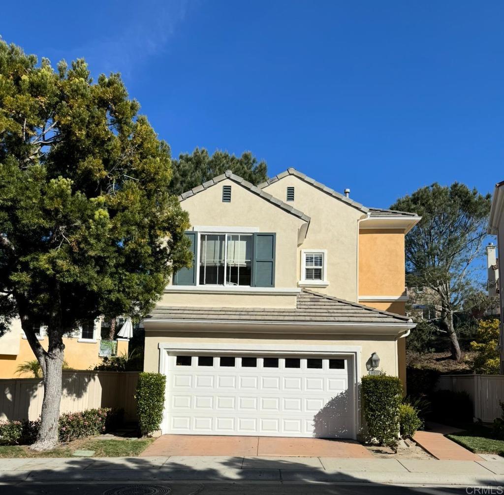 11377 Carmel Creek Rd, San Diego, CA 92130 - traditional-style home featuring a garage, stucco siding, and driveway