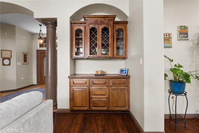 1806 Briercliff Ct, Bakersfield, CA 93311 - indoor dry bar with dark wood-type flooring, ornate columns, and arched walkways