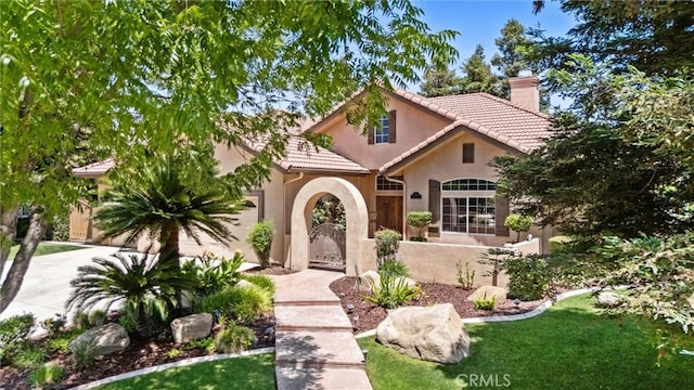 1806 Briercliff Ct, Bakersfield, CA 93311 - mediterranean / spanish house with a chimney, stucco siding, a tiled roof, a gate, and driveway