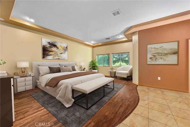 1806 Briercliff Ct, Bakersfield, CA 93311 - bedroom with a tray ceiling, light wood-style floors, and recessed lighting