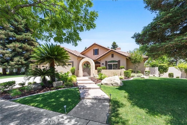 1806 Briercliff Ct, Bakersfield, CA 93311 - mediterranean / spanish-style home featuring stucco siding, a chimney, a tile roof, and an attached garage