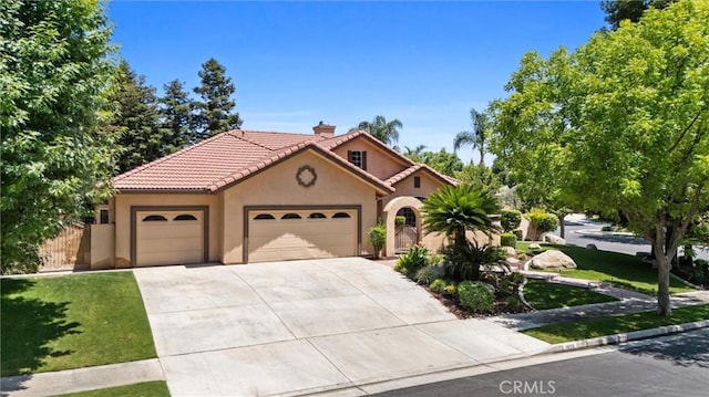 1806 Briercliff Ct, Bakersfield, CA 93311 - mediterranean / spanish-style home with an attached garage, stucco siding, a chimney, driveway, and a tile roof