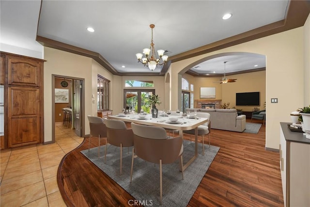 1806 Briercliff Ct, Bakersfield, CA 93311 - dining space featuring arched walkways, a lit fireplace, crown molding, recessed lighting, and a ceiling fan