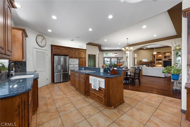 1806 Briercliff Ct, Bakersfield, CA 93311 - kitchen featuring stainless steel appliances, light tile patterned flooring, a center island, open floor plan, and backsplash