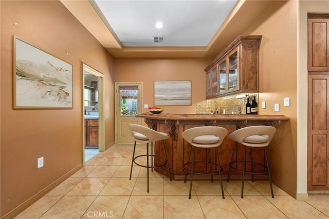 1806 Briercliff Ct, Bakersfield, CA 93311 - indoor wet bar with a tray ceiling and light tile patterned flooring