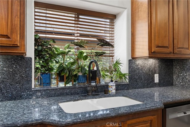 1806 Briercliff Ct, Bakersfield, CA 93311 - kitchen with dishwasher, brown cabinets, backsplash, and dark stone counters